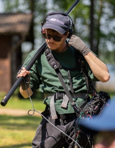 sound operator on movie set with boom microphone